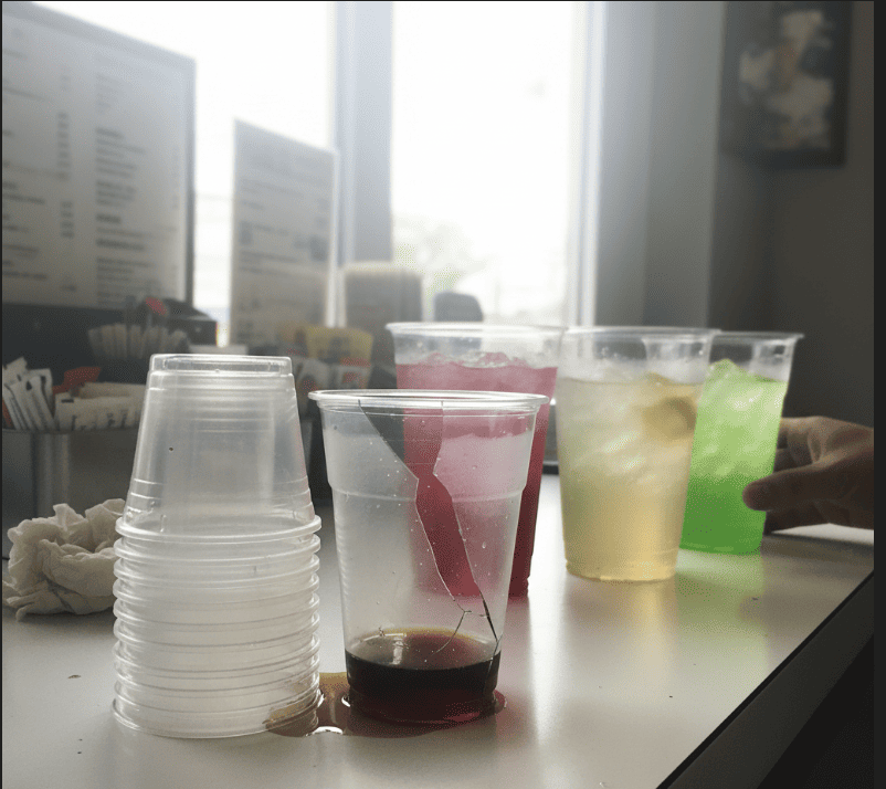 A row of clear [PET cups](https://gmz.ltd/top-6-advantages-of-pet-plastic-cups-for-your-beverage-business/)<sup id=